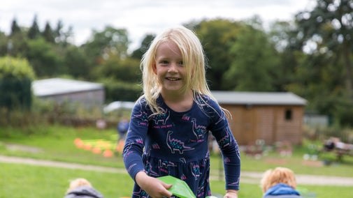 A child playing with lawn games about to throw a plastic disc